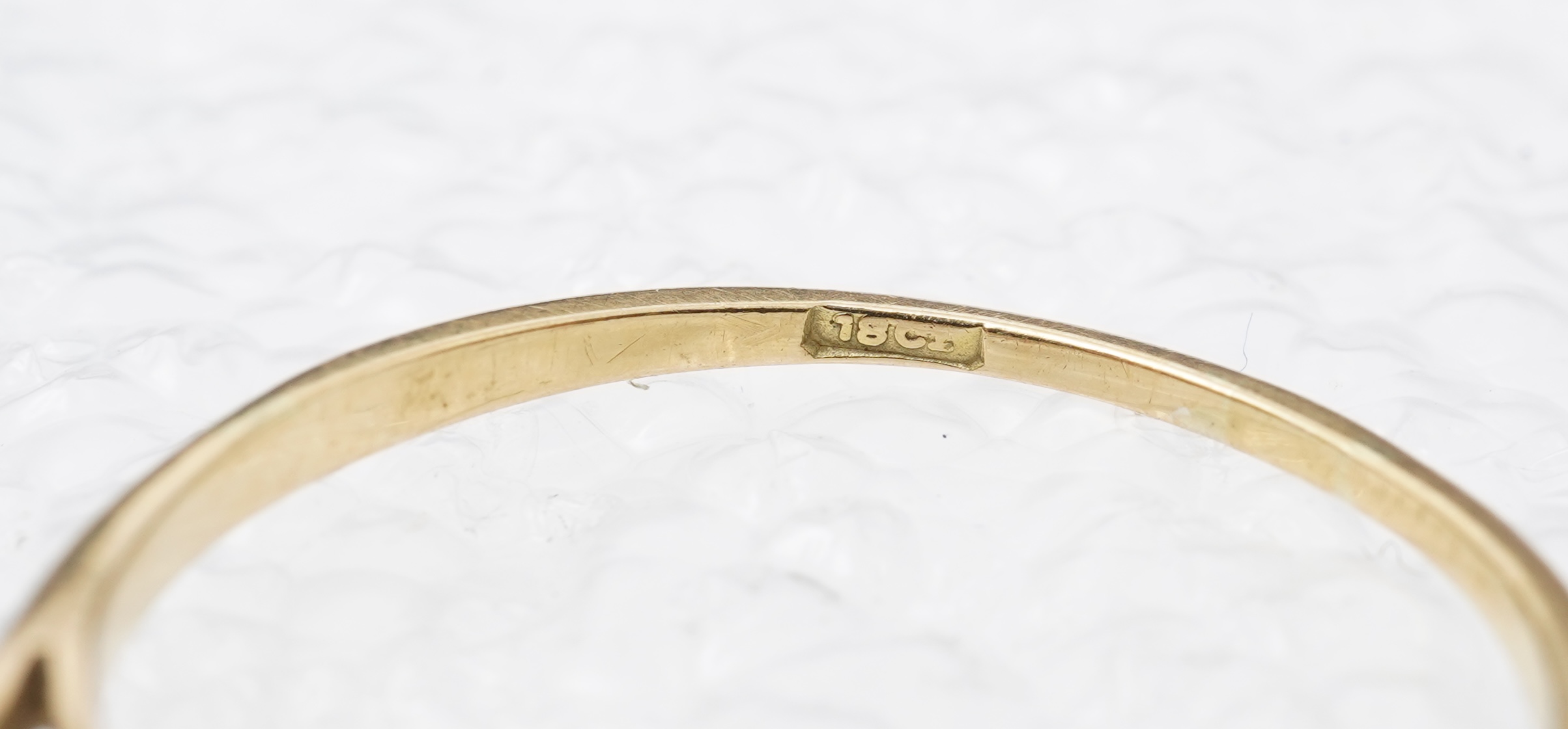 A diamond three-stone ring, set with three circular-cut diamonds totalling approximately 0.50 carats, mounted in gold, size O, stamped 18CT, gross weight approximately 2 grams